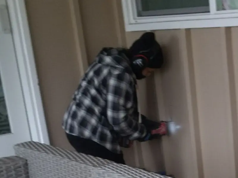 Professional electrician installing an exterior outlet in Garfield