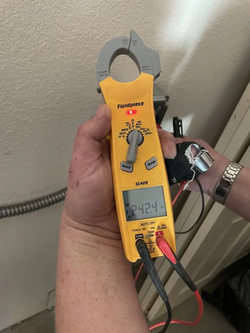 Voltage testing with clamp meter during Outlet Installation in Garfield